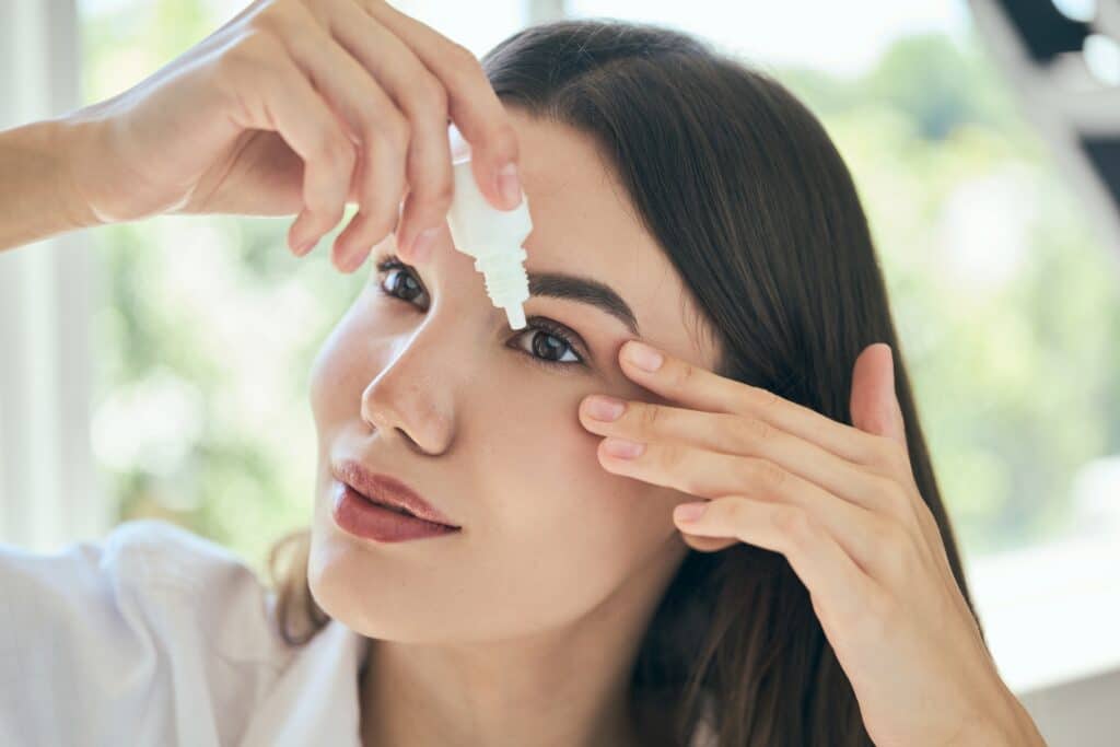 Woman using eye drops to help with dry eyes