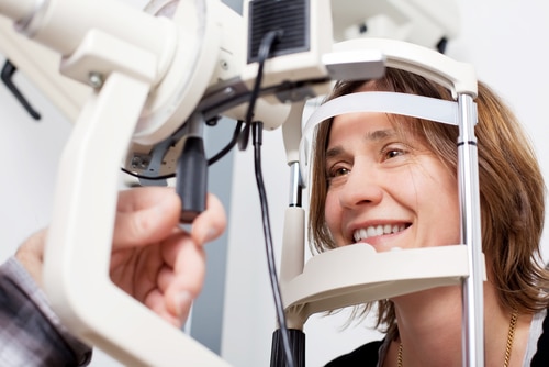Woman getting eye exam at eye doctor's office.
