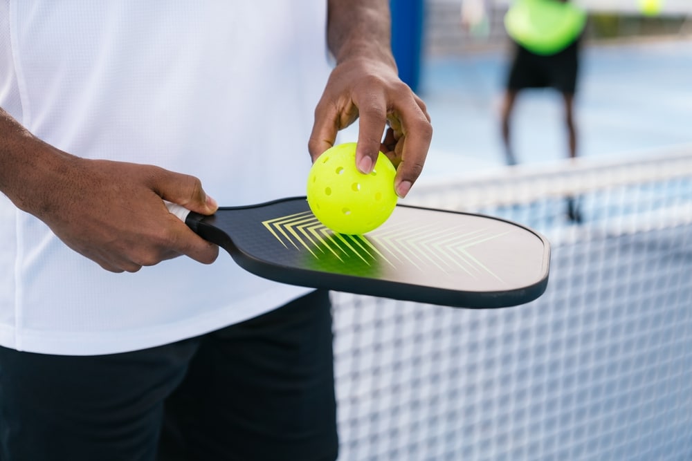 Man holding pickleball