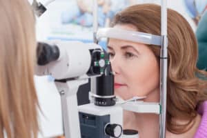Young woman undergoing an eye examination to evaluate vision and corneal health.