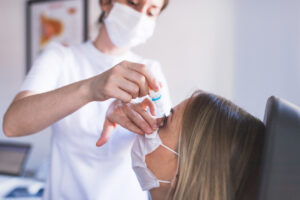 Eye doctor examining a patient for dry eye symptoms.